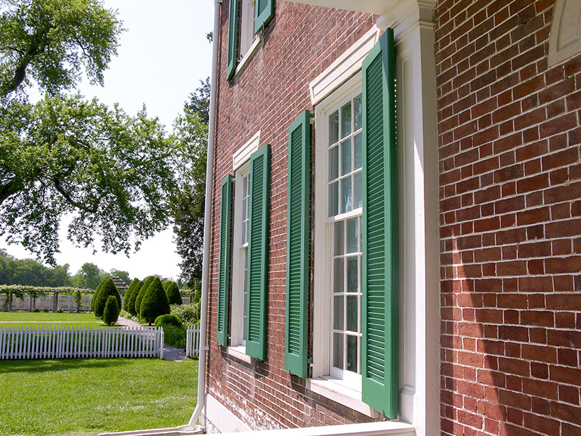 side view of green window shutters